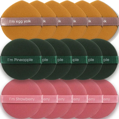 A set of 18 makeup blending sponges in three colors. Each has a ribbon with the text "I'm egg yolk" (yellow), "I'm pineapple" (green), and "I'm strawberry" (pink).
