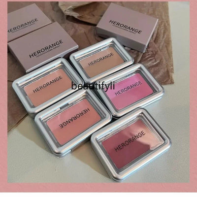 A flat lay of six small, square blush compacts from the brand Herorange. The blushes are arranged in two rows of three, with the top row showing the product packaging and the bottom row showing the opened compacts with different shades of blush.
