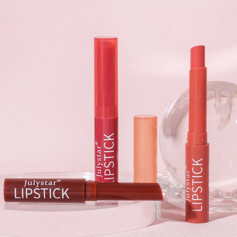 Three tubes of Julystar brand lipstick in different shades of pink and red.