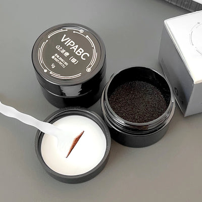 An open jar of brown eyebrow powder with a small scoop resting on the lid. The jar has Chinese characters printed on the top, indicating the brand name "VIPABC" and the shade number
